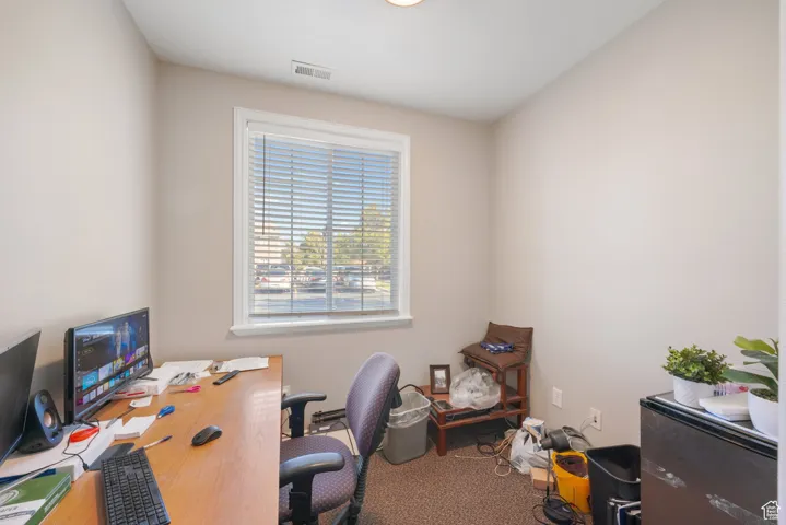 Carpeted office space with a healthy amount of sunlight