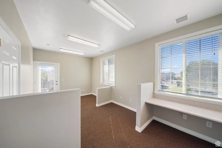 Carpeted empty room with a healthy amount of sunlight