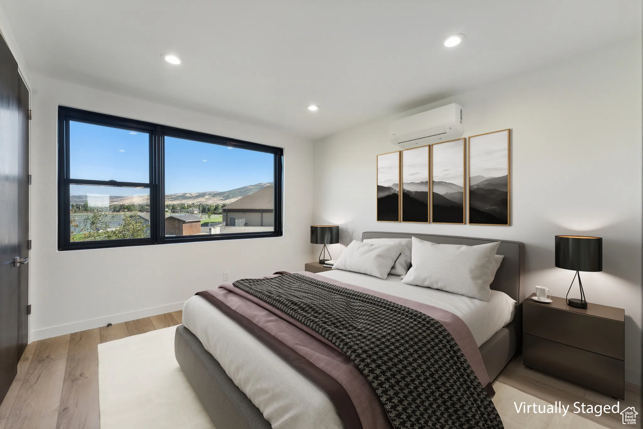 Bedroom with light wood-type flooring and an AC wall unit
