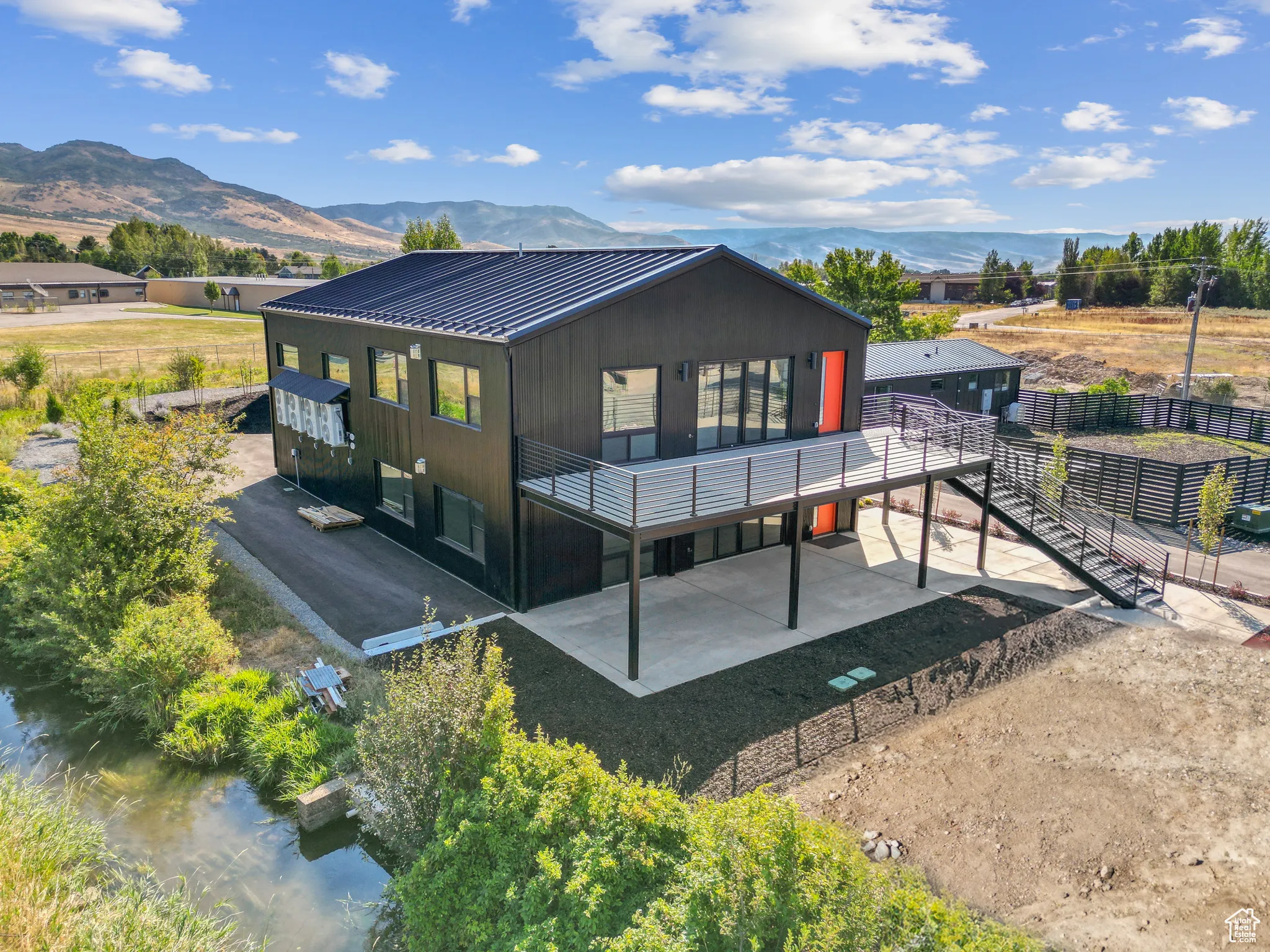 Rear view of property with a water and mountain view