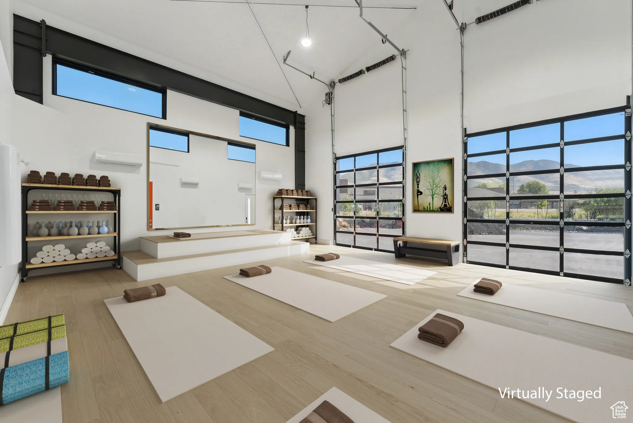 Interior space featuring a mountain view, hardwood / wood-style flooring, a wall mounted air conditioner, and a high ceiling