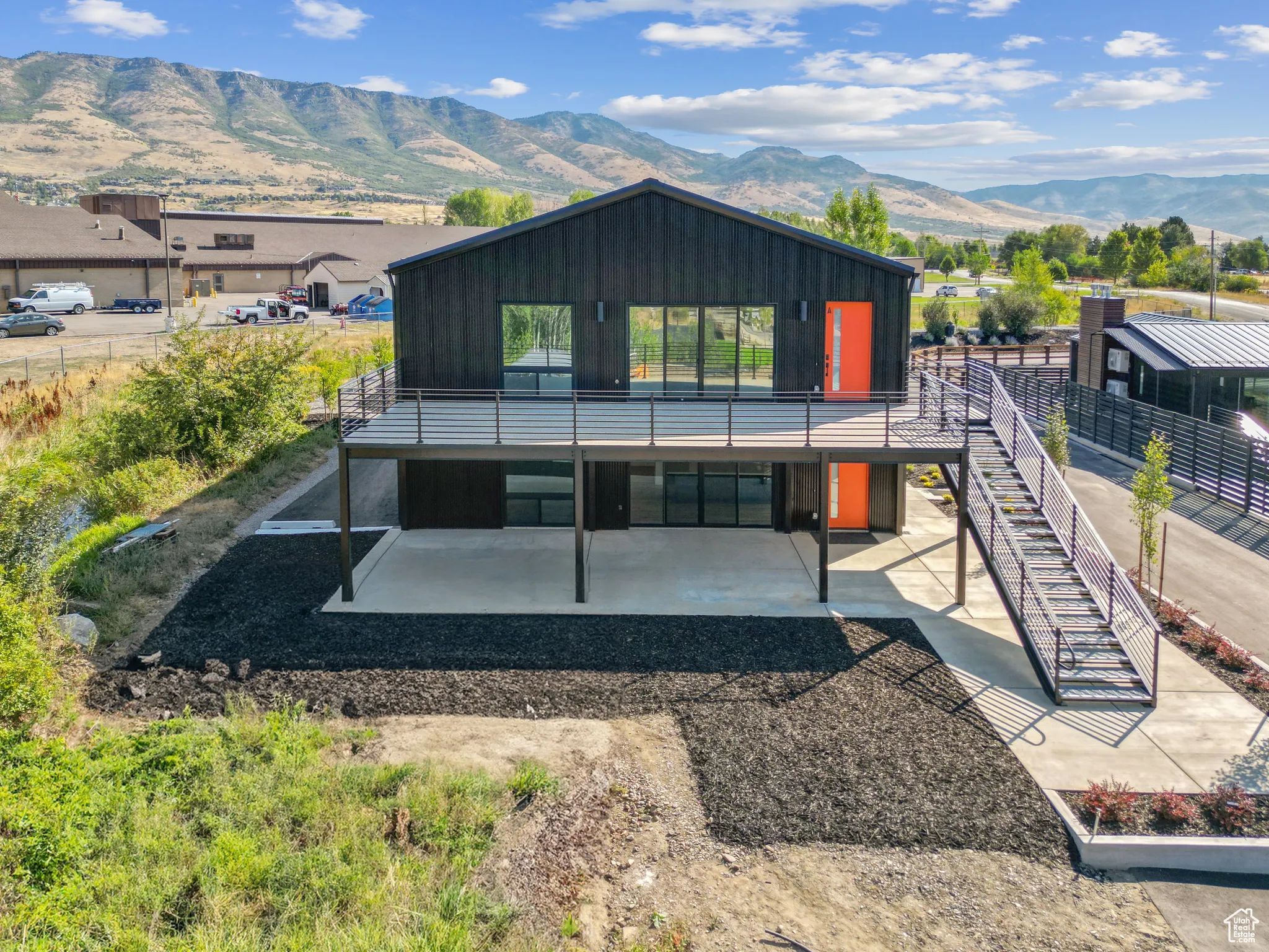 Rear view of house featuring a mountain view and a patio area