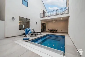 View of pool with a jacuzzi and a patio area