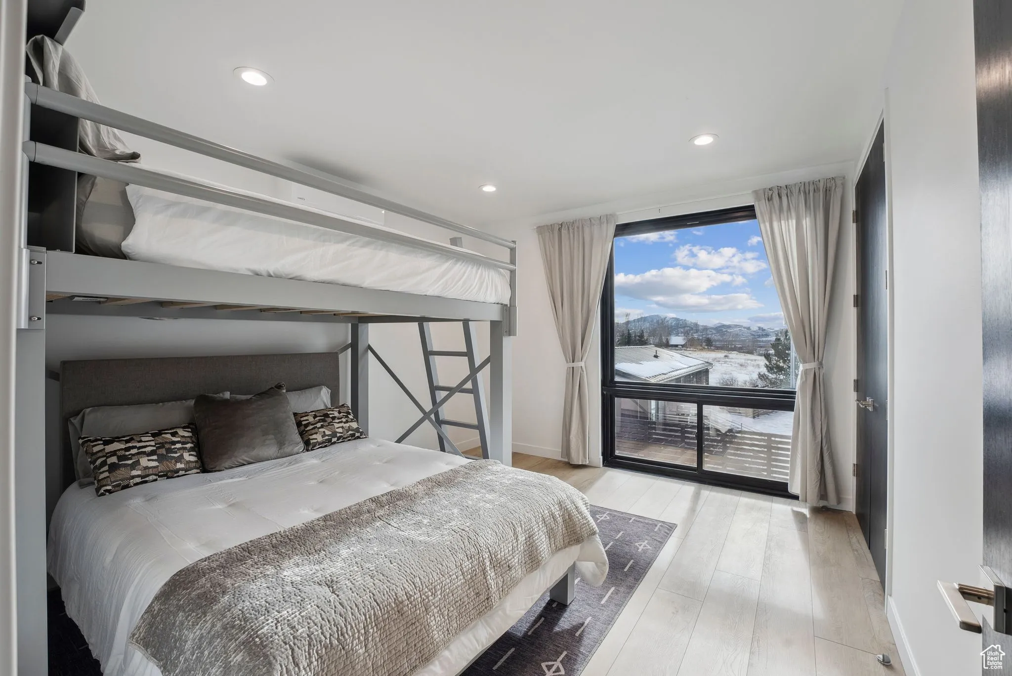 Bedroom with light hardwood / wood-style flooring