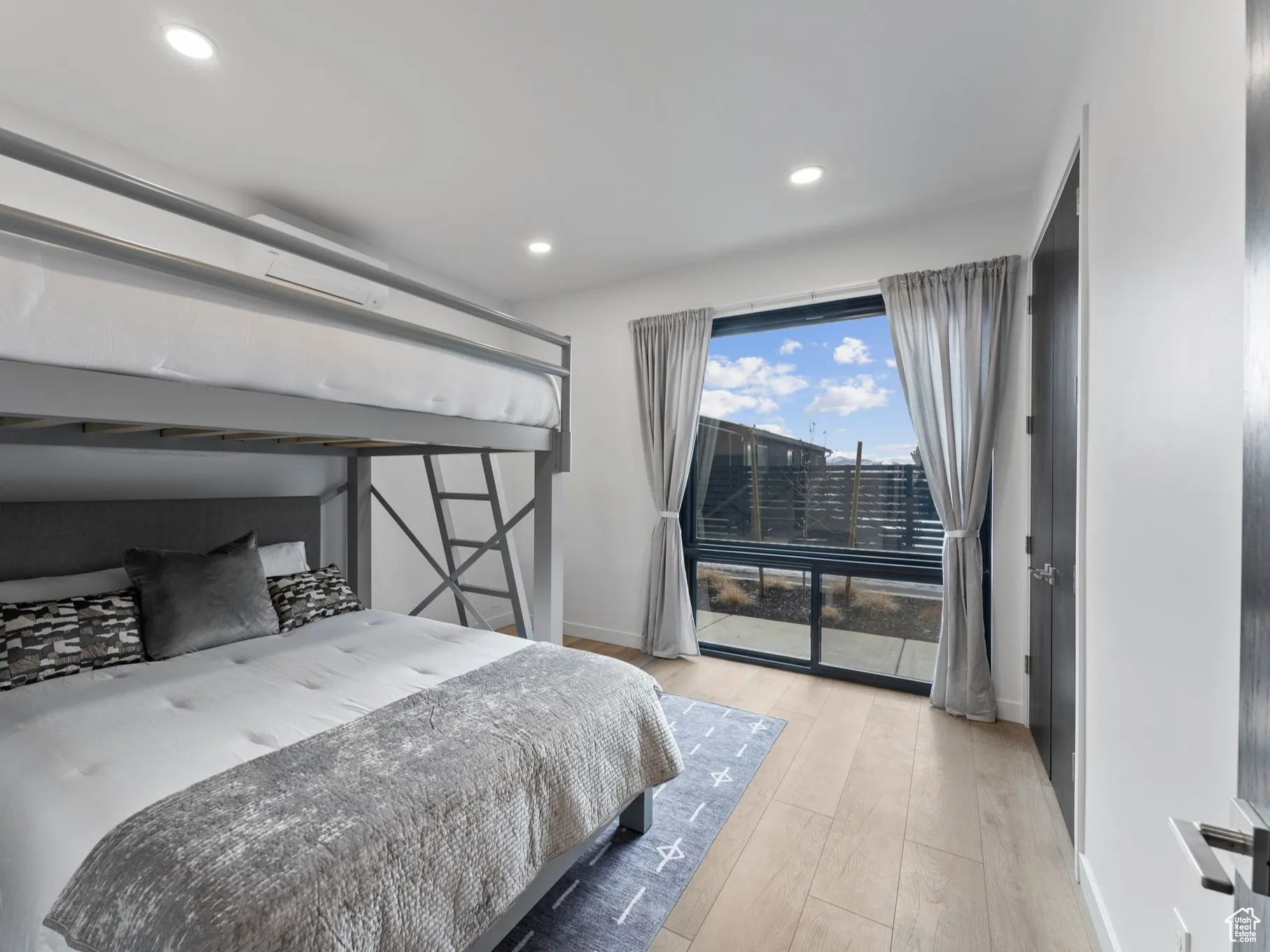 Bedroom with light hardwood / wood-style floors