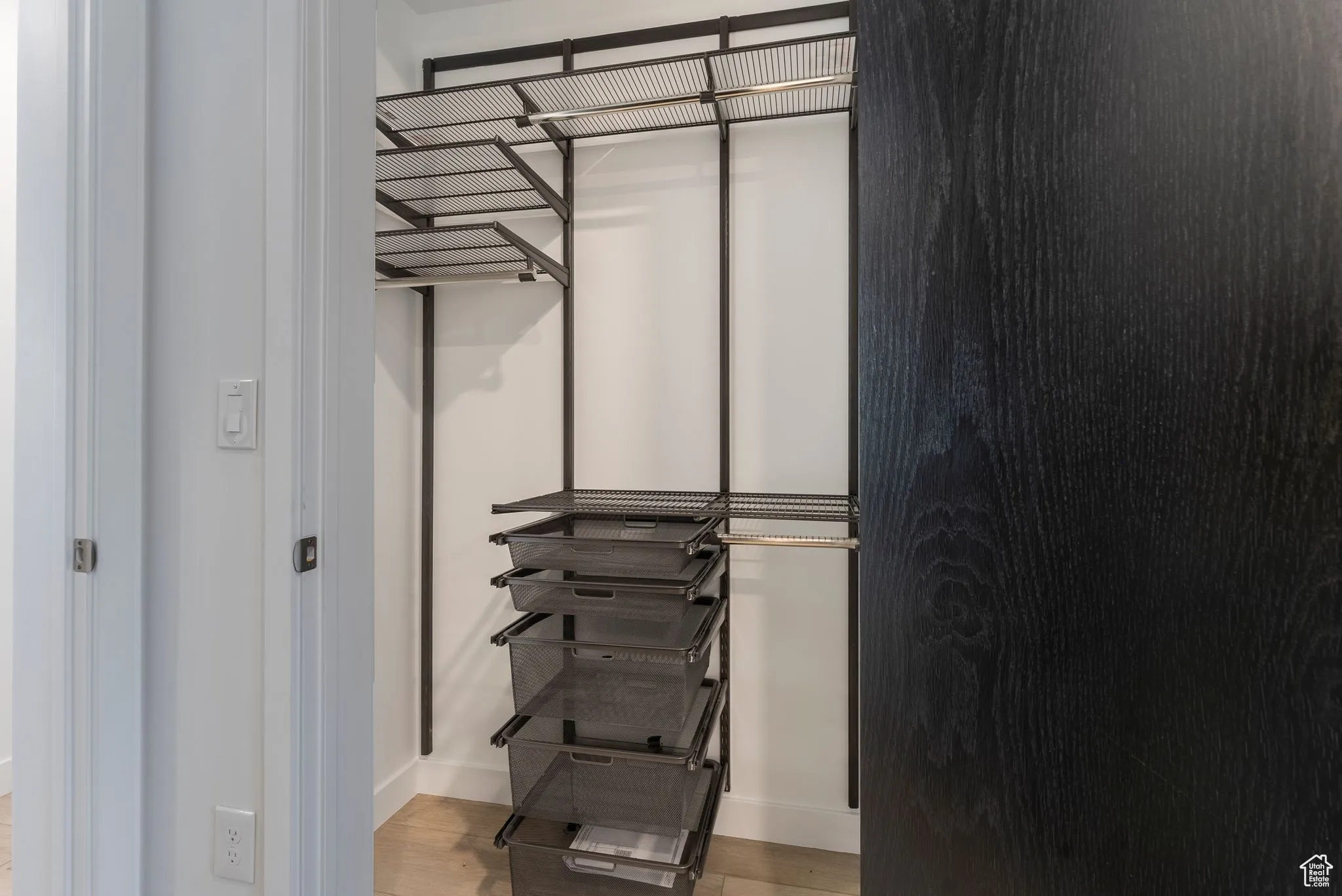 Spacious closet featuring light wood-type flooring