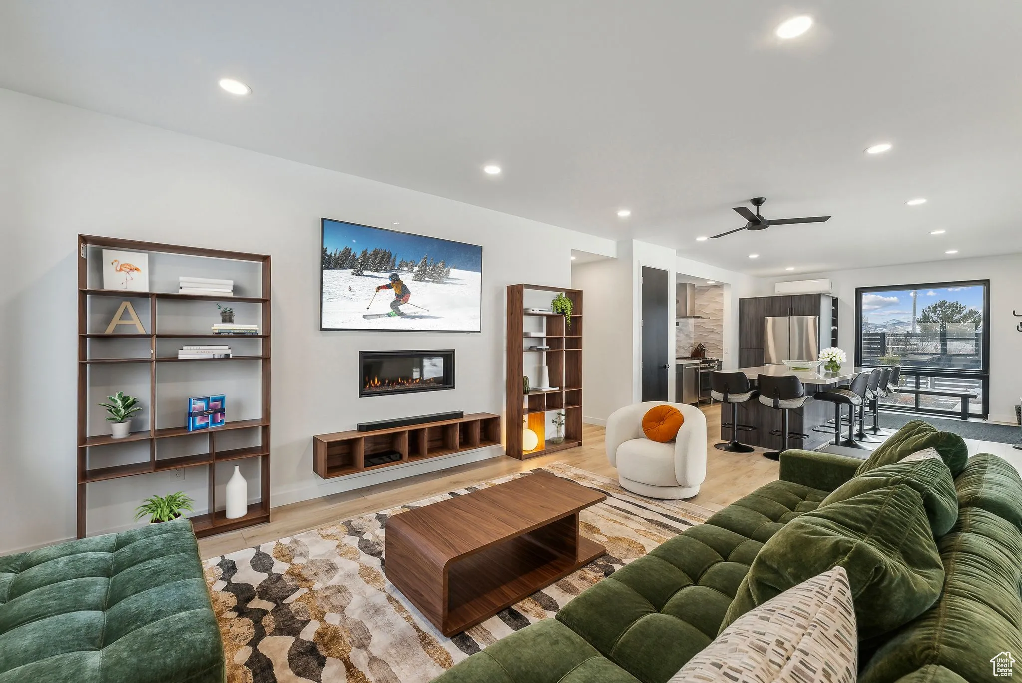 Living room featuring ceiling fan and light hardwood / wood-style floors