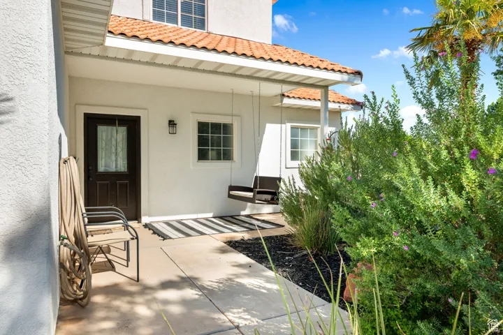 Doorway to property featuring a patio