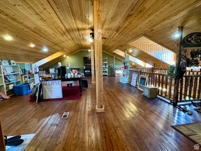 Interior space featuring ceiling fan, hardwood / wood-style flooring, lofted ceiling, and wooden ceiling