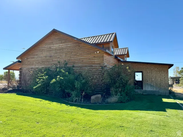 View of home's exterior with a yard