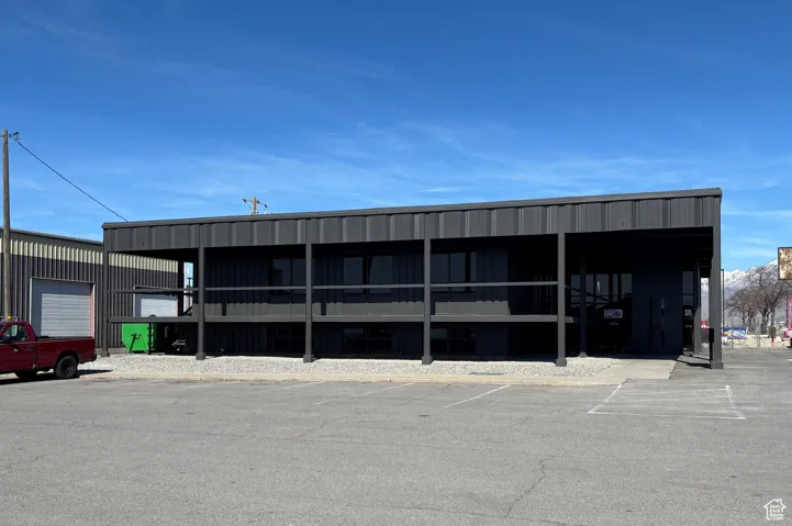 View of building exterior featuring uncovered parking