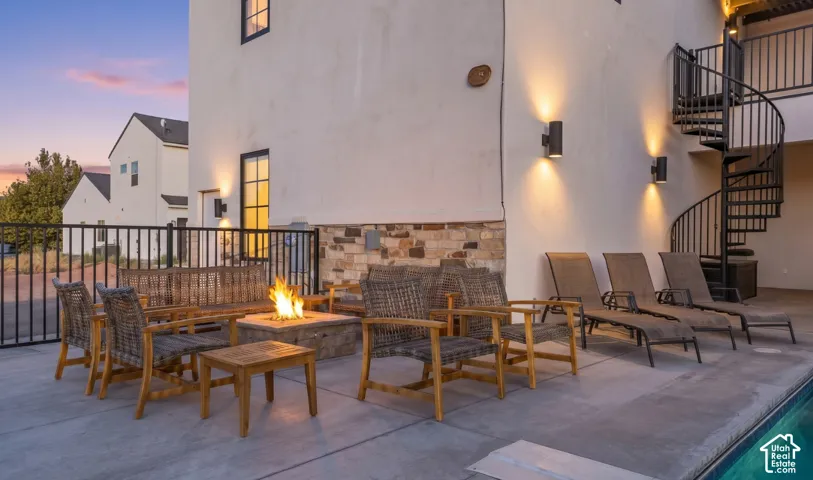 The gas fire pit and poolside lounge, set against a stacked-stone wall.