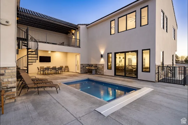 Pool featuring a patio, outdoor dining area, and stairway