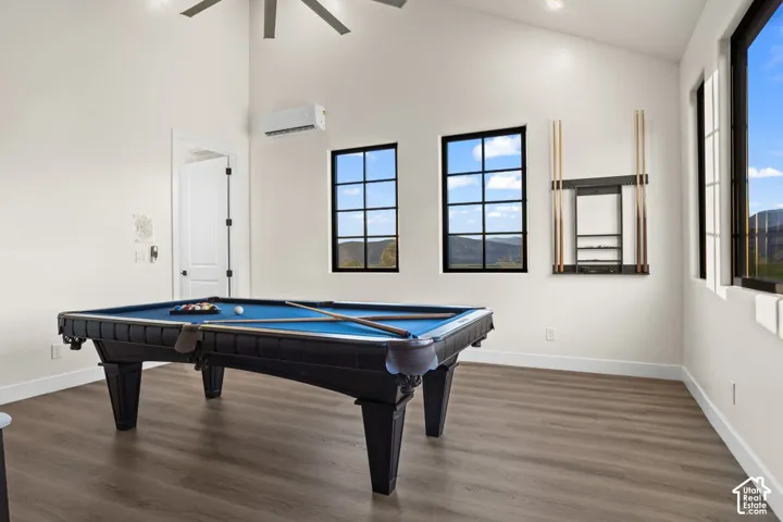 The pool table sits under vaulted ceilings in the upstairs recreation room.