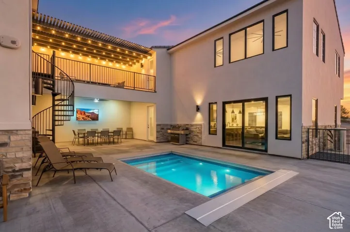 A heated private pool, a covered patio with a TV, and a spiral staircase up to the caf
