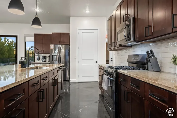 A gas range, stainless appliances, and a pantry make cooking for a big group easy.