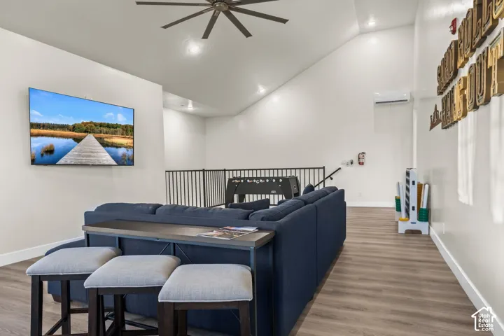 The other end of the 38-foot Hang-Out, with bar seating and a TV under vaulted ceilings.