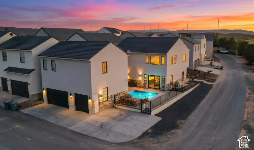 The home at twilight on its corner lot, with several additional parking spaces steps from the front door.