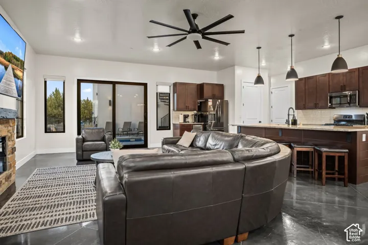 The open great room flows into the kitchen, with sliding doors straight out to the heated pool.