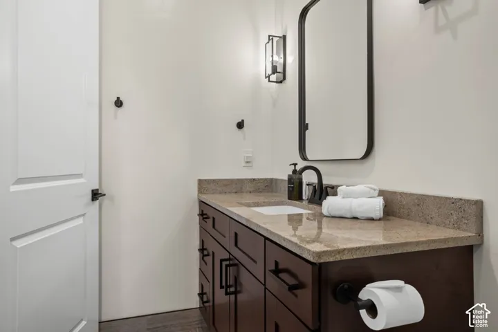 A bathroom vanity with a stone countertop.