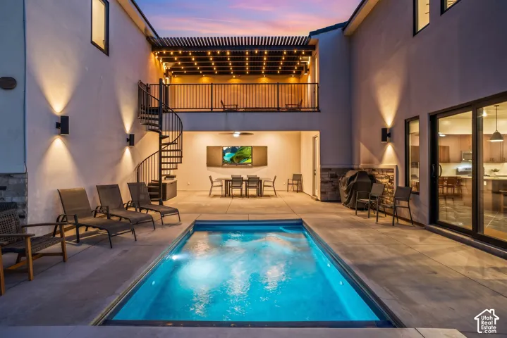 After dark, the heated pool glows below the covered patio and the caf