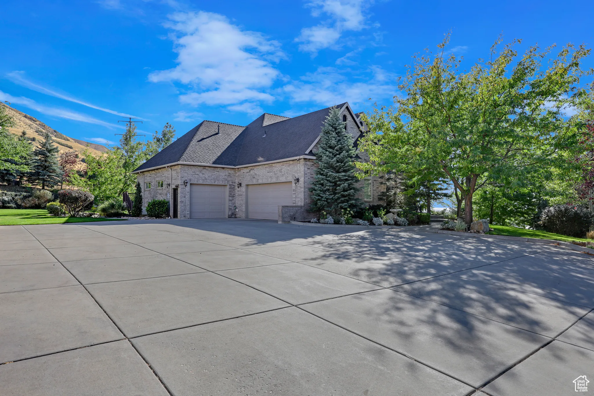 View of side of property featuring a garage and a mountain view