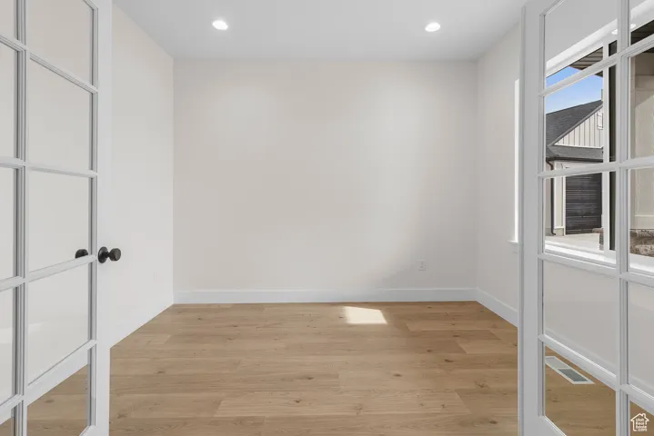 Spare room with recessed lighting, baseboards, visible vents, and light wood finished floors