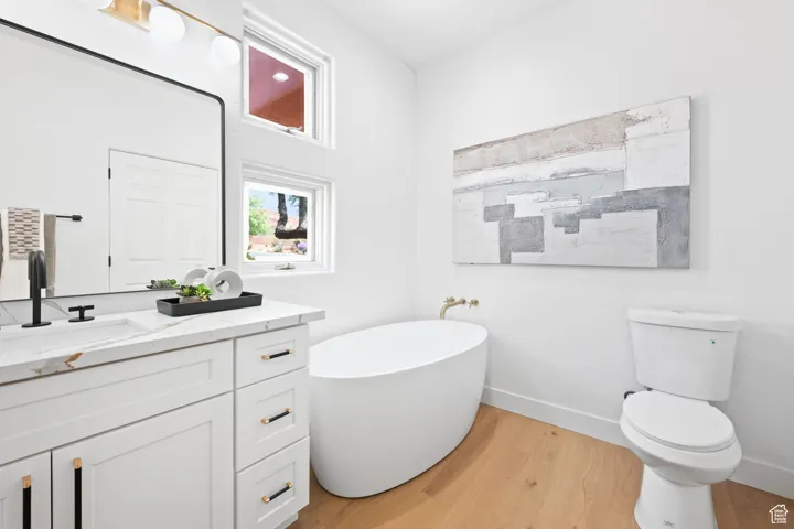 Guest bath includes a free standing tub under two windows for natural light and fresh air.