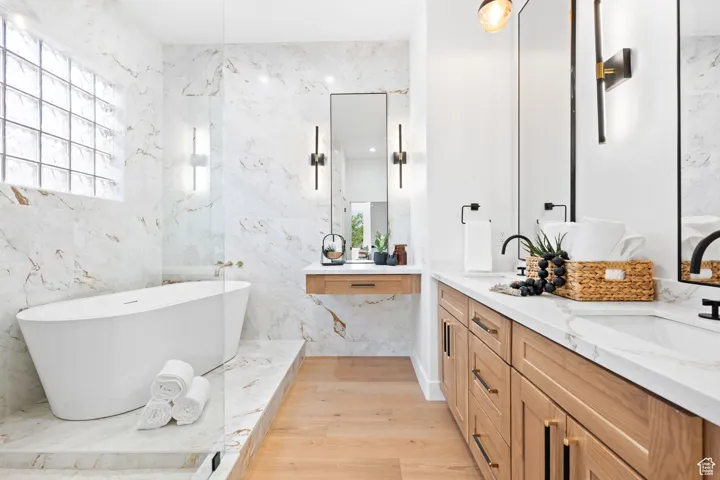 Master bathroom featuring a spacious walk-in shower, a freestanding tub, a dual-sink vanity, and a dedicated floating vanity space.