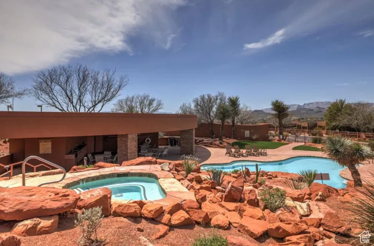 A few steps from the heated pool ad hot tub with a covered patio.