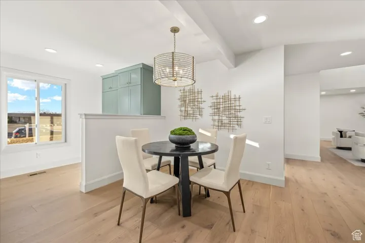 Dining room with recessed lighting, beam ceiling, light wood-style flooring, and baseboards