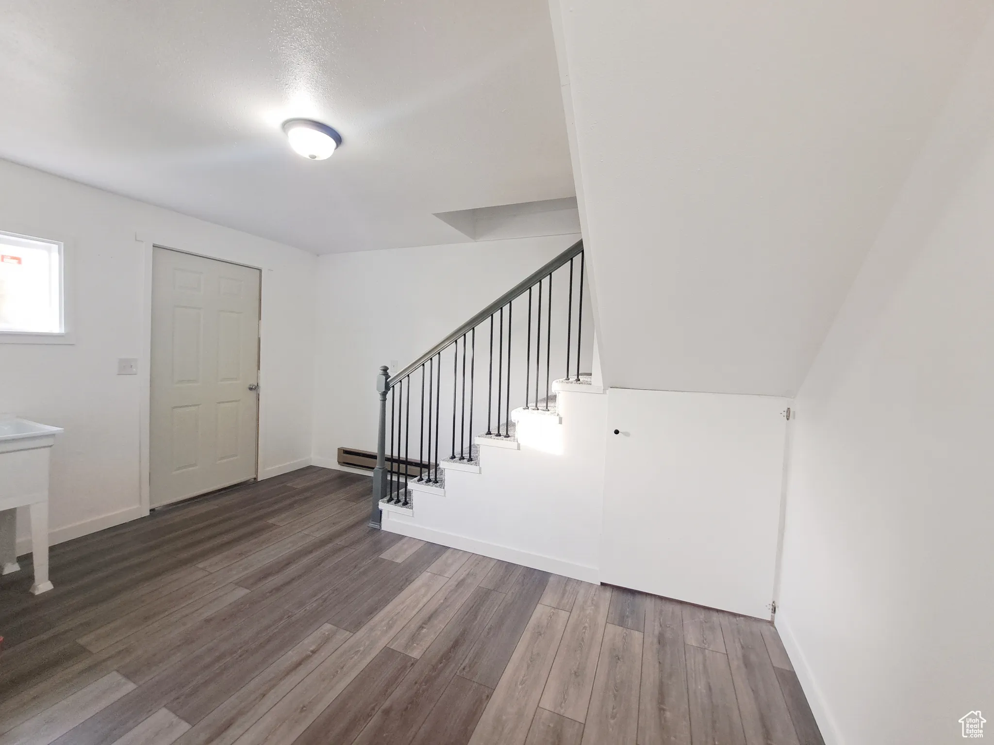 Laundry/ Mud Room/Foyer with New LVP flooring, New Paint, New Doors, New Carpet, New Railing.