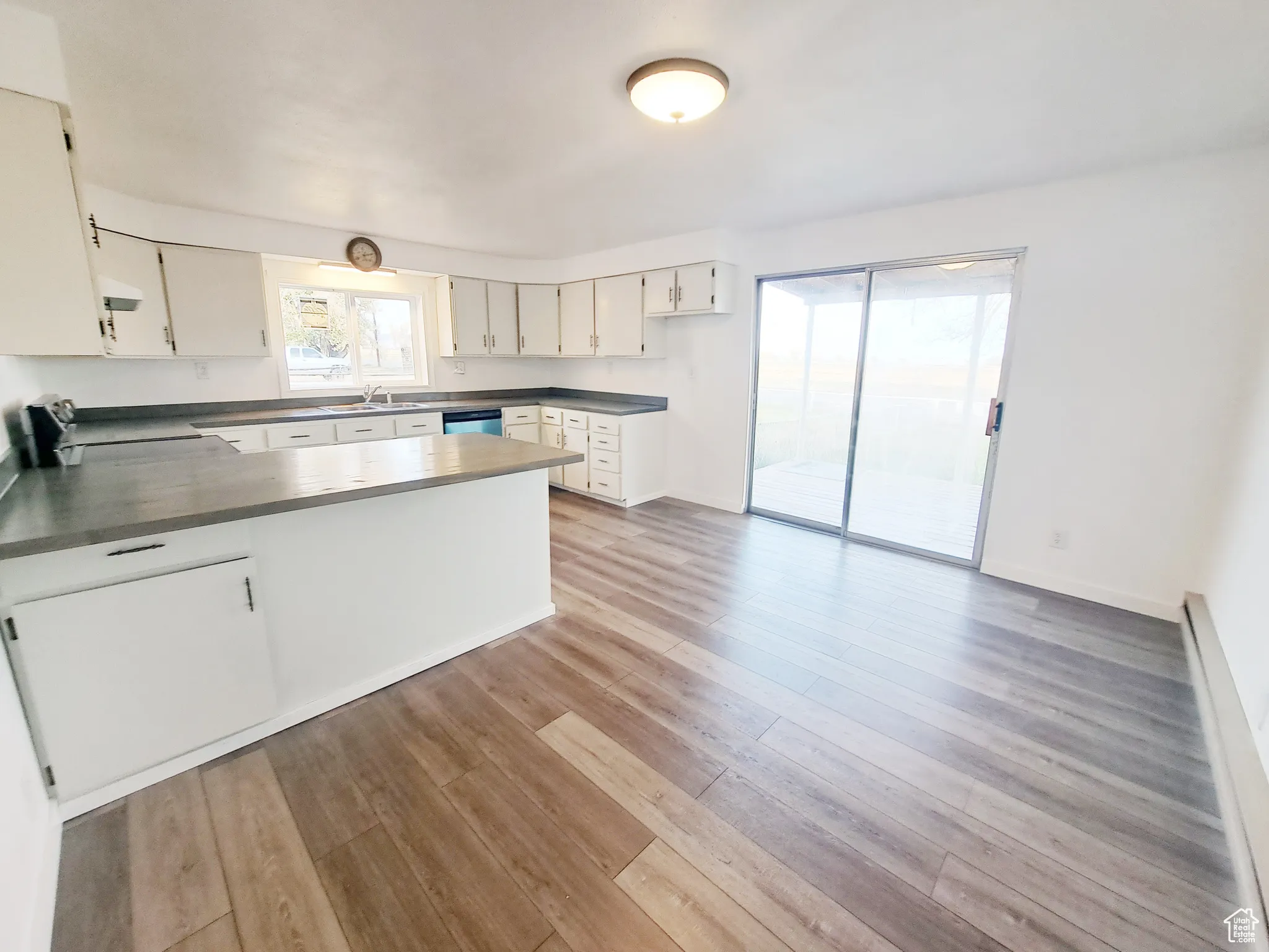 Kitchen with sink, stainless steel dishwasher, Large Dining Area, New LVP flooring, New Appliances, New Paint, New Butcher Block Countertops, and white cabinets