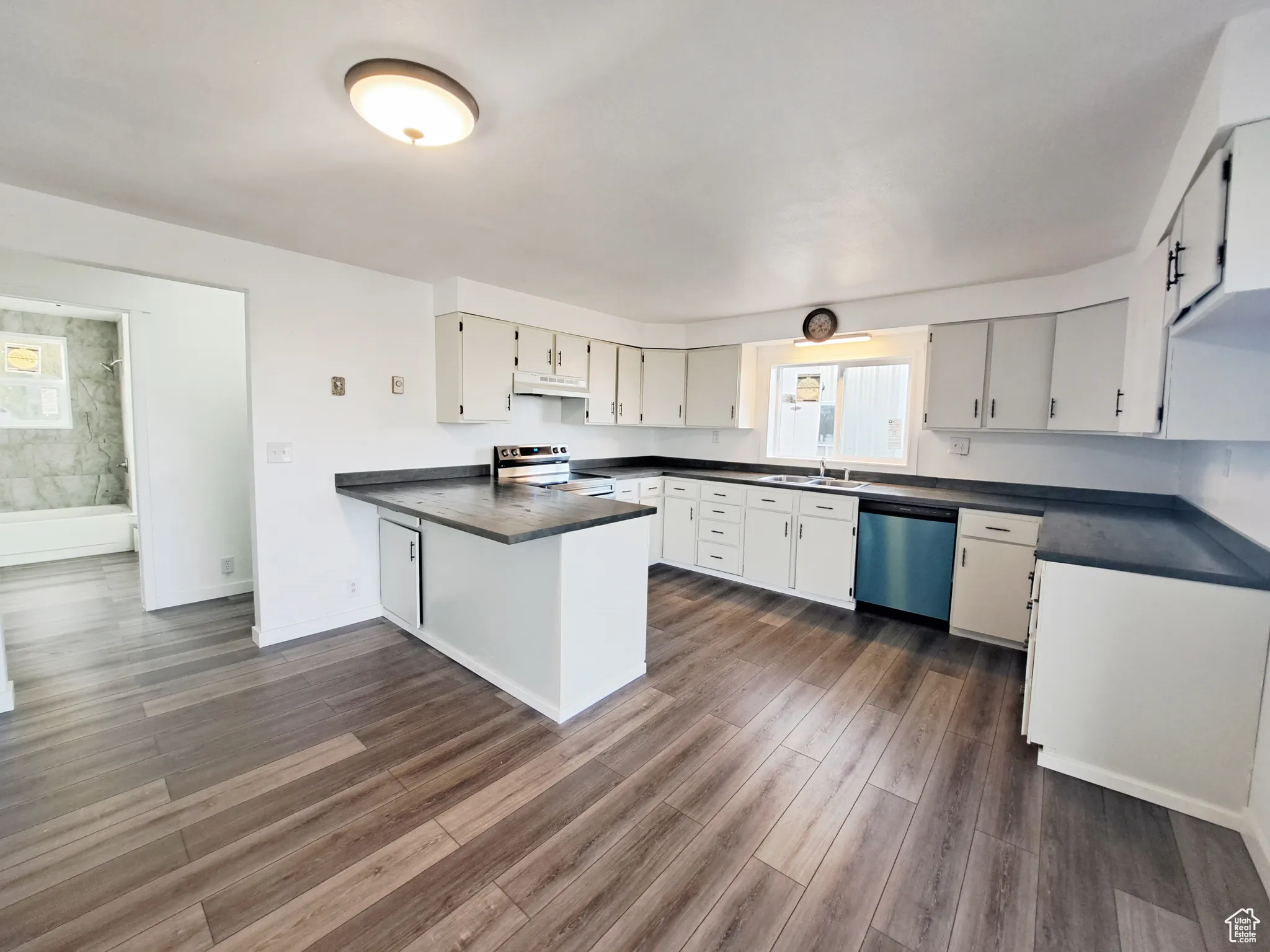 Kitchen featuring stainless steel appliances, New LVP flooring, sink, New Appliances, New Paint, New Butcher Block Countertops, and plenty of natural light
