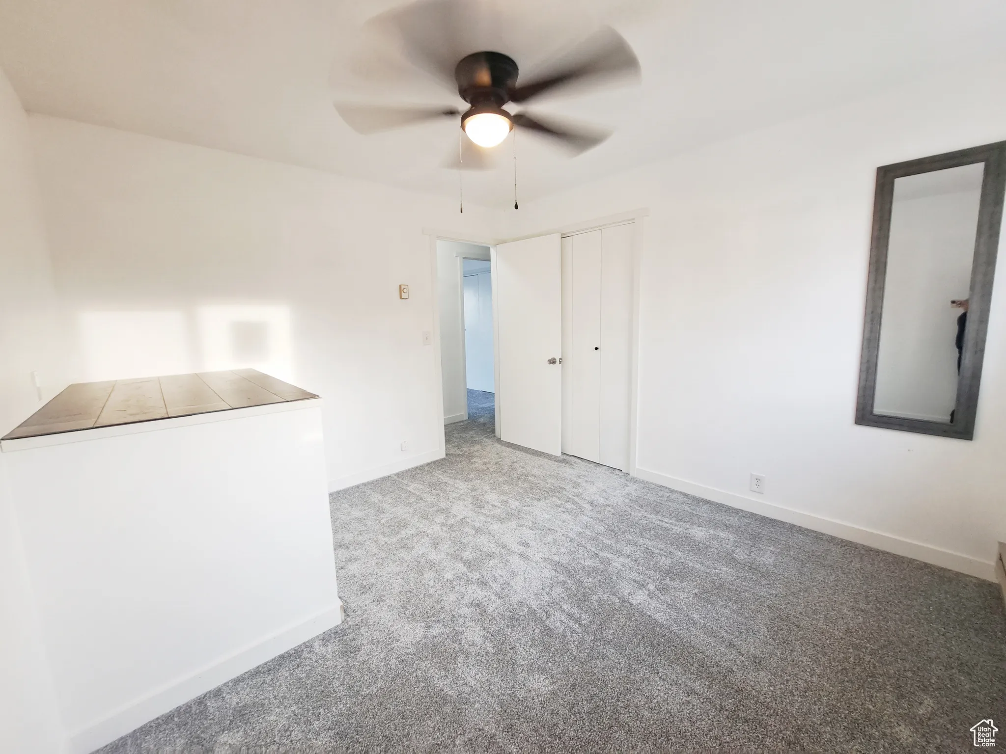 Bedroom 3, with New Windows, New Paint, New Doors, New Carpet, with a baseboard heating unit, plenty of natural light, and New ceiling fan