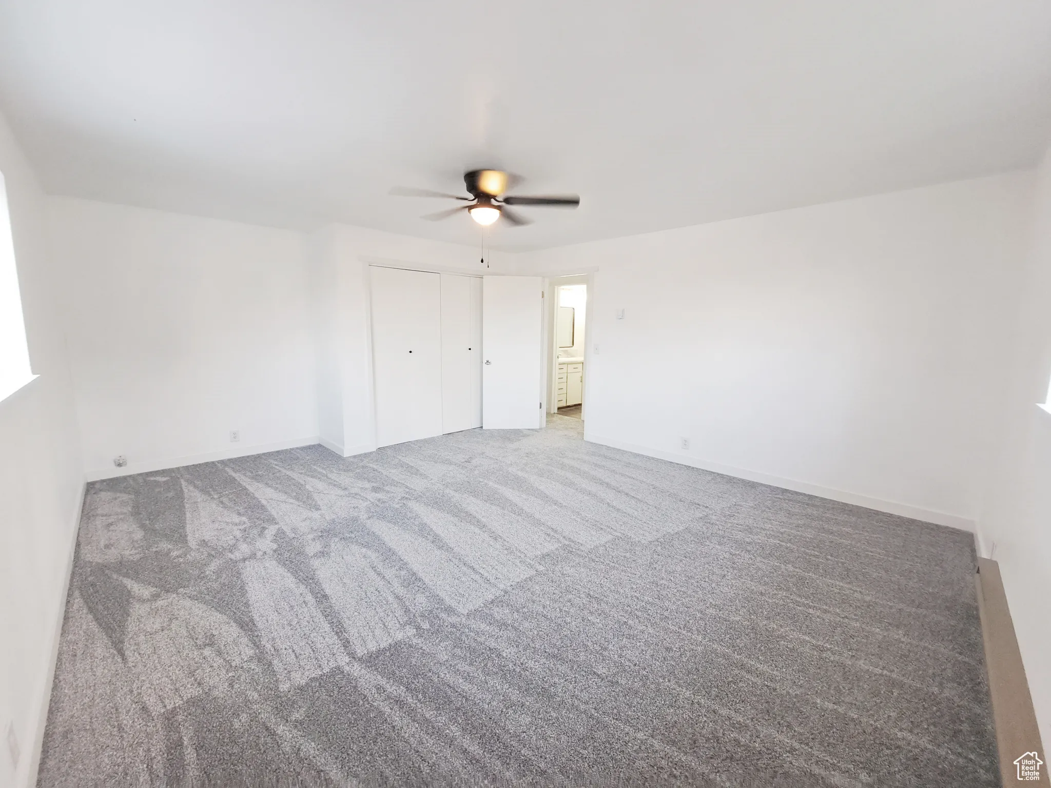 Bedroom 3, with New Windows, New Paint, New Doors, New Carpet, with a baseboard heating unit, plenty of natural light, and New ceiling fan