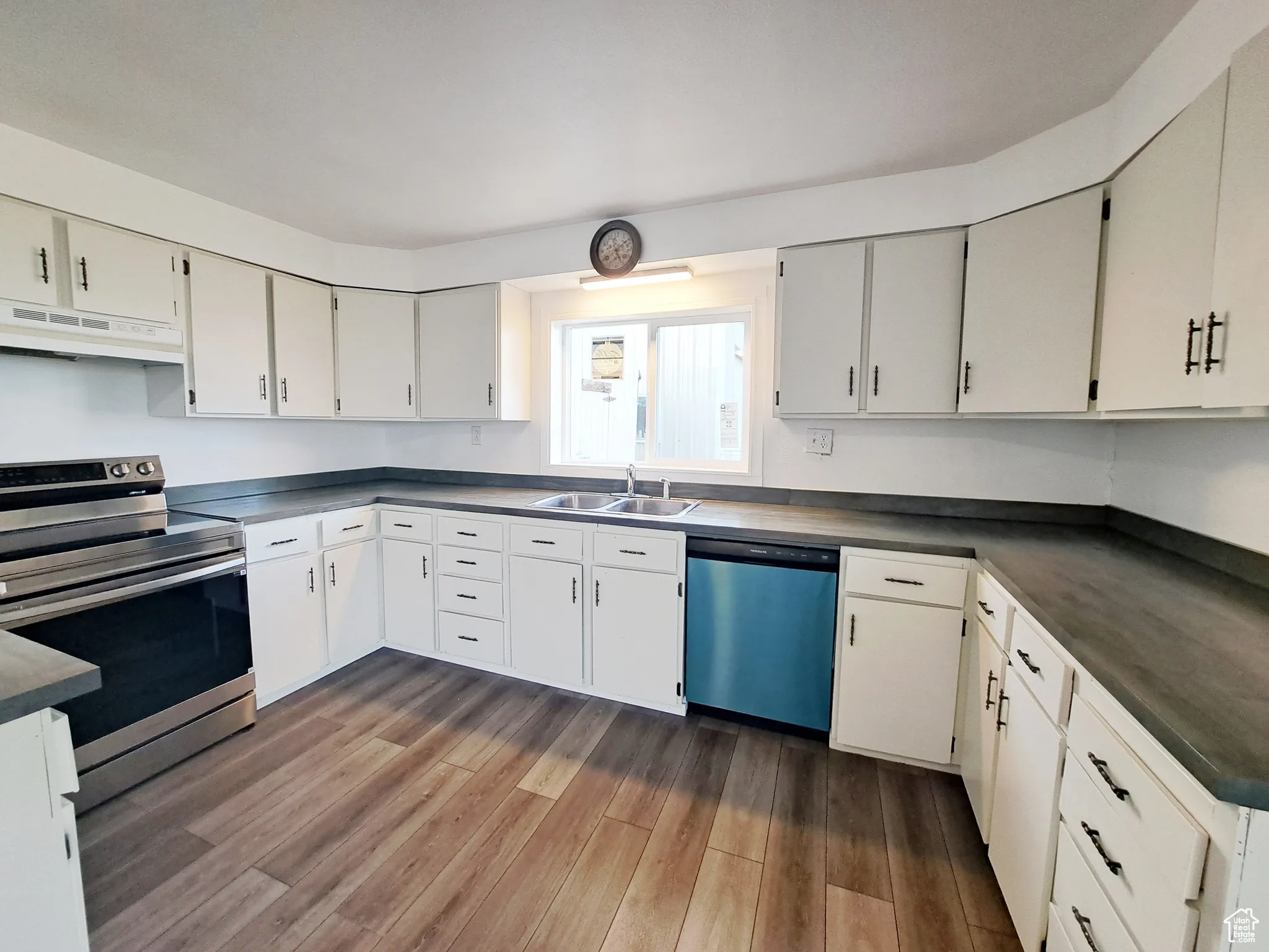 Kitchen featuring white cabinets, New Paint, sink, New range, and New appliances with stainless steel finishes