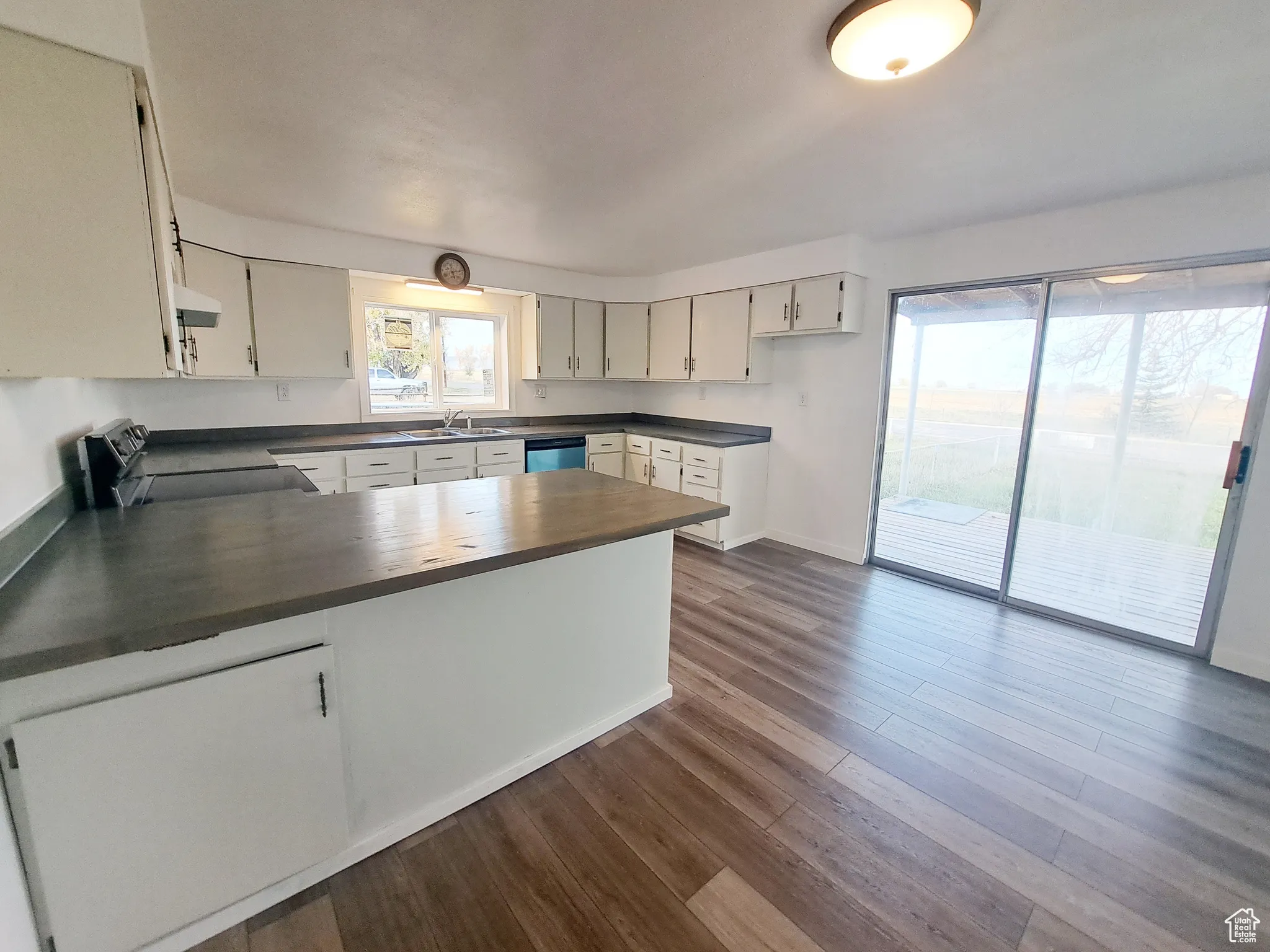 Kitchen featuring kitchen peninsula, stove, sink, and New LVP flooring, New Appliances, New Paint, New Butcher Block Countertops