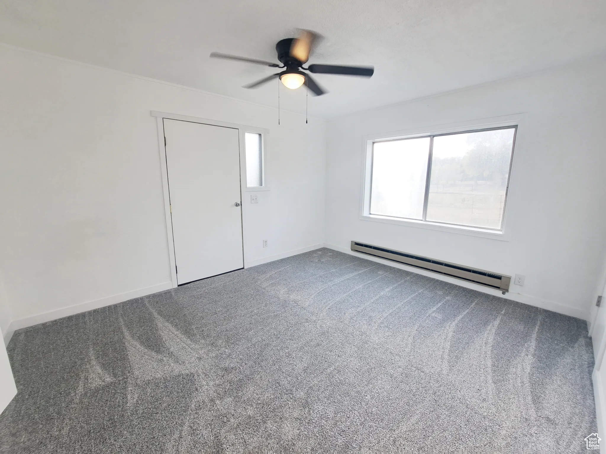 Bedroom 1, New Carpet, New Paint, New Ceiling Fan, New Door, and a baseboard heating unit