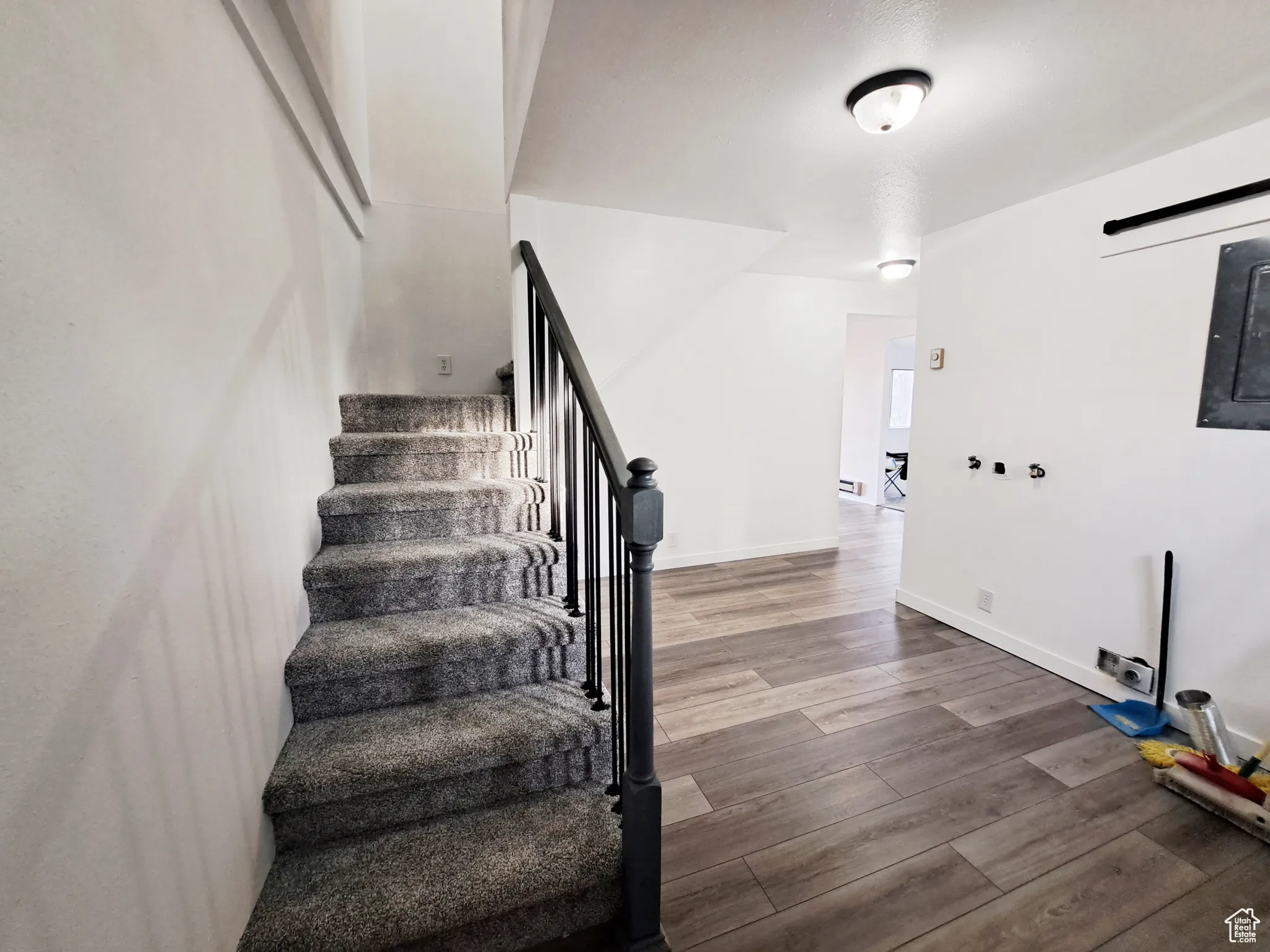 Laundry/ Mud Room/Foyer with New LVP flooring, New Paint, New Doors, New Carpet, New Railing.