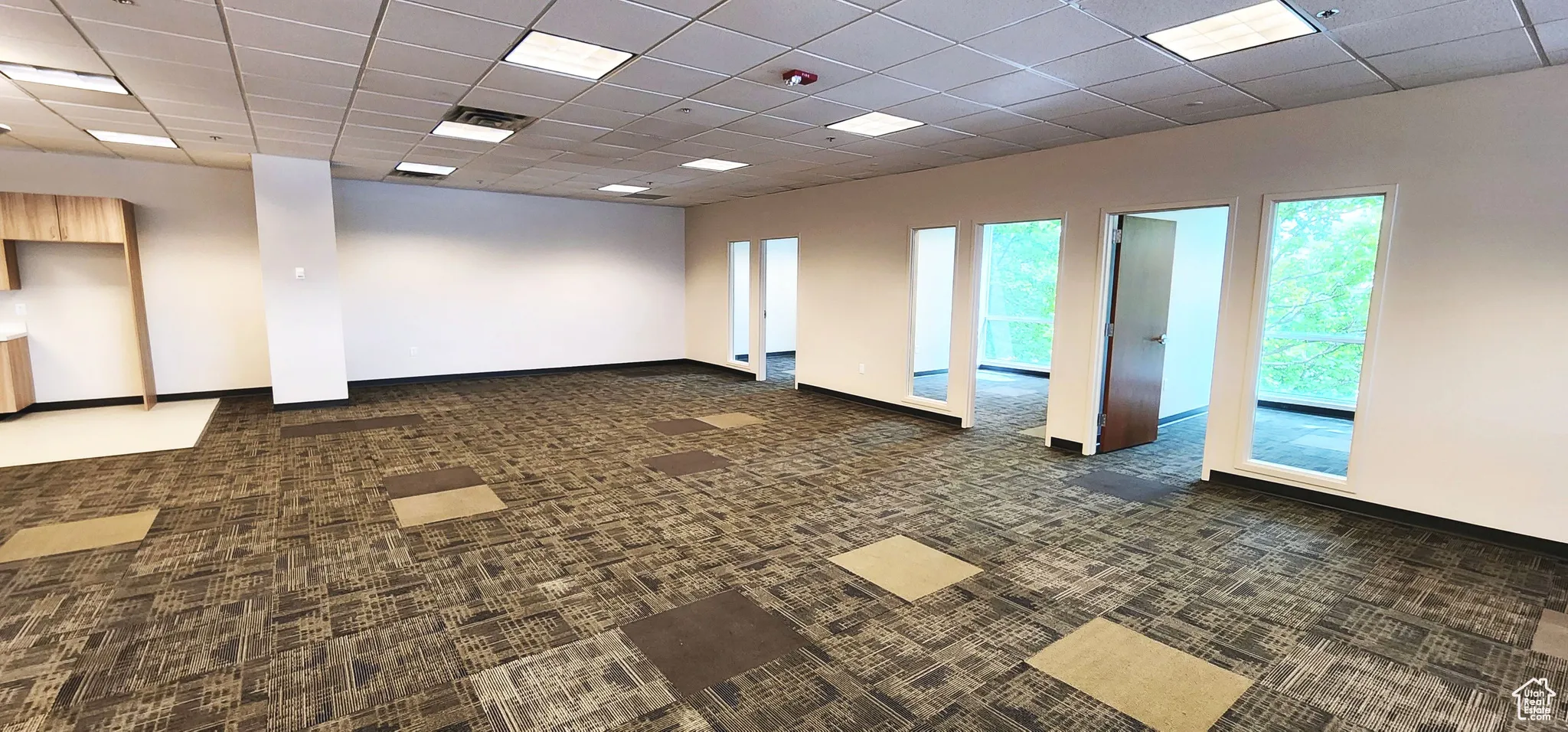Empty room featuring a paneled ceiling