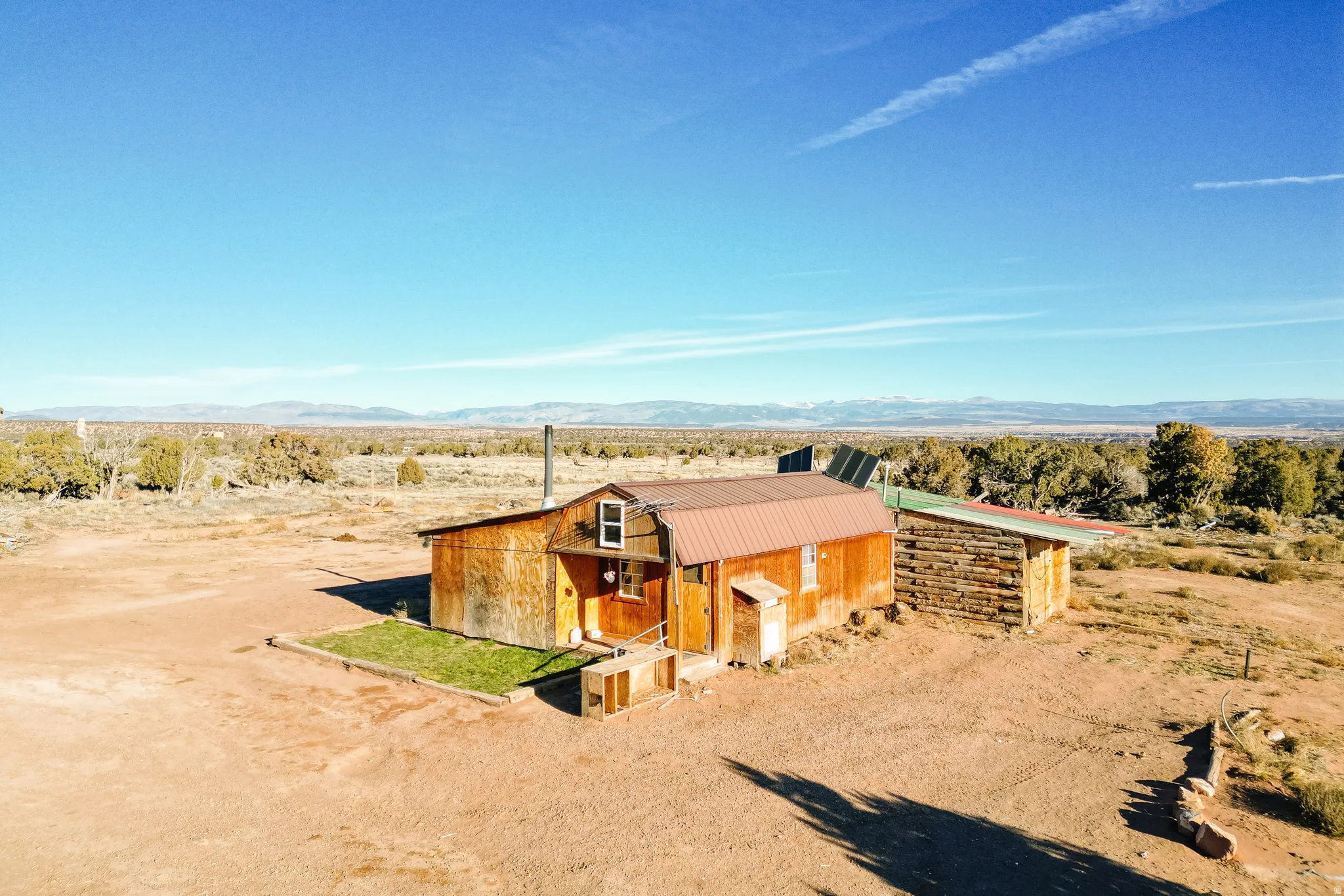 View of front of property featuring a mountain view, a porch, a view of rural / pastoral area, a metal roof, and an outdoor structure