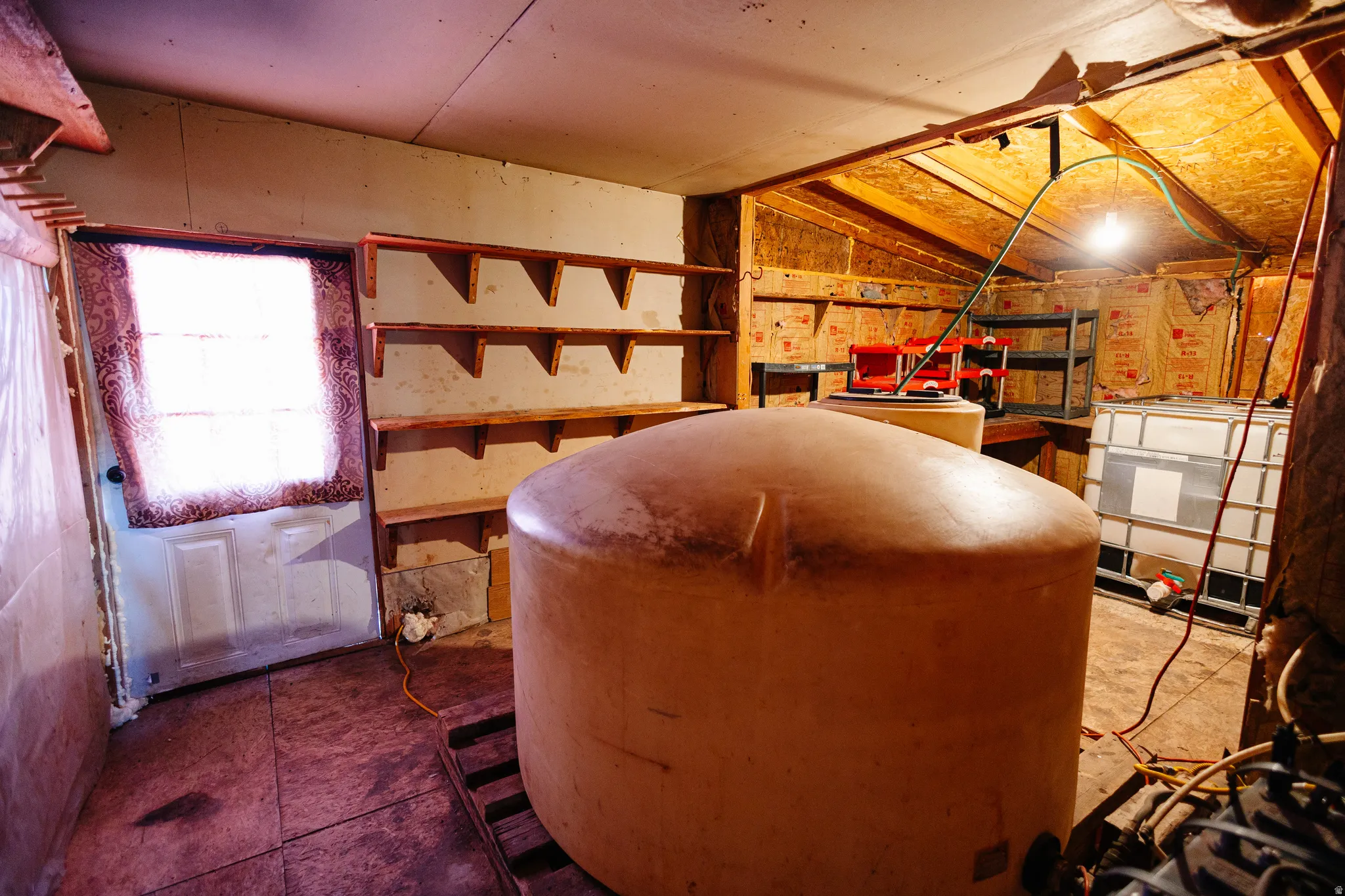Utility room with water tank.