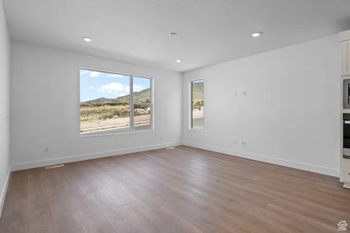 Spare room with hardwood / wood-style floors and a textured ceiling