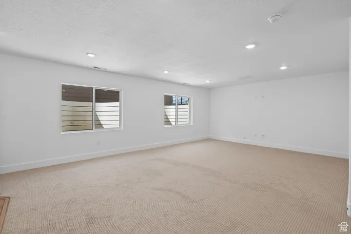 Carpeted empty room with a textured ceiling