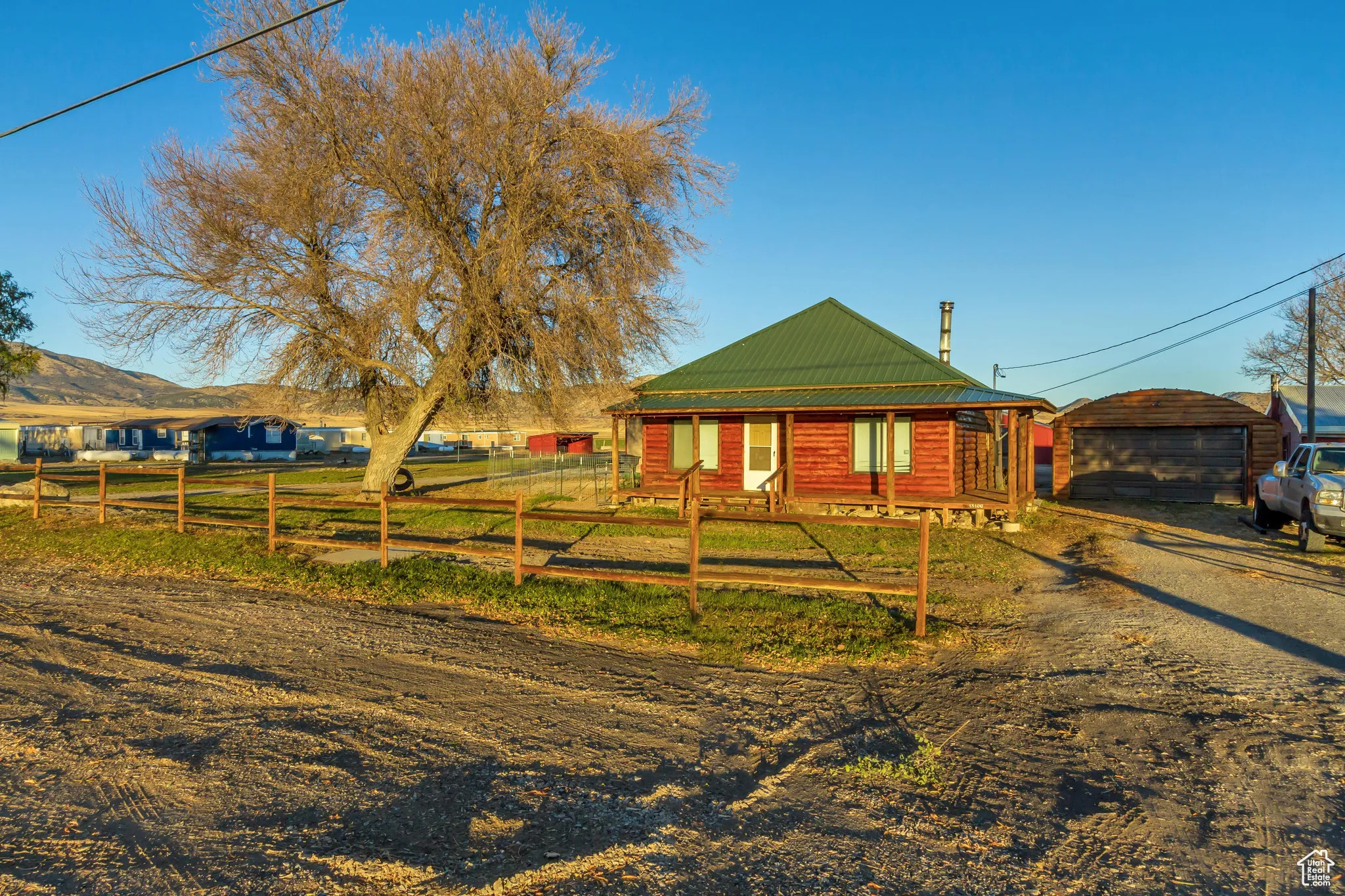 View of front facade featuring an outbuilding and a garage