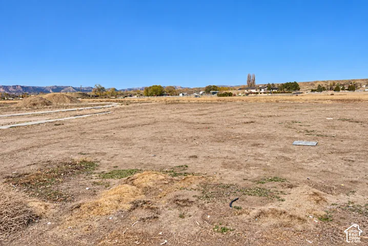 Expansive lot featuring a clear, level ground surface and distant mountain scenery