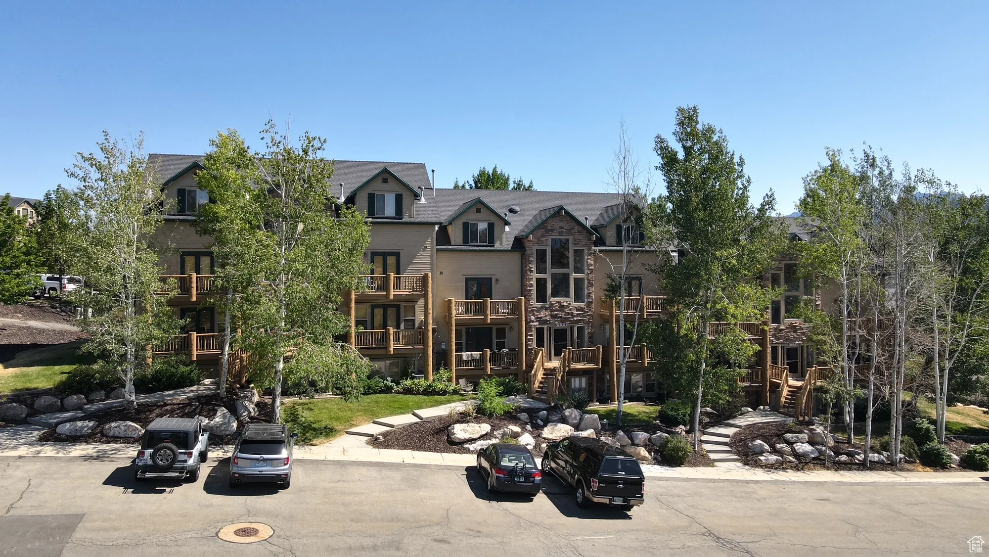 View of front facade with stone siding and stairway