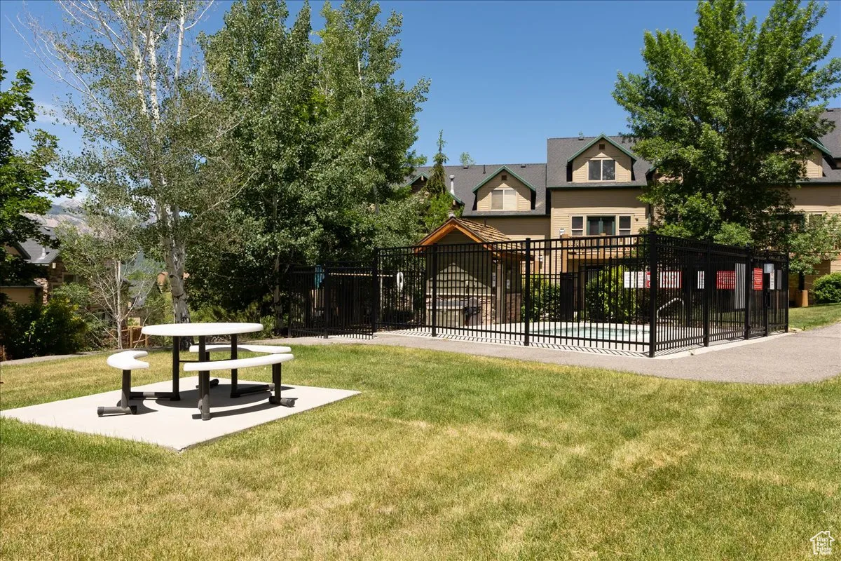 View of home's community with a yard