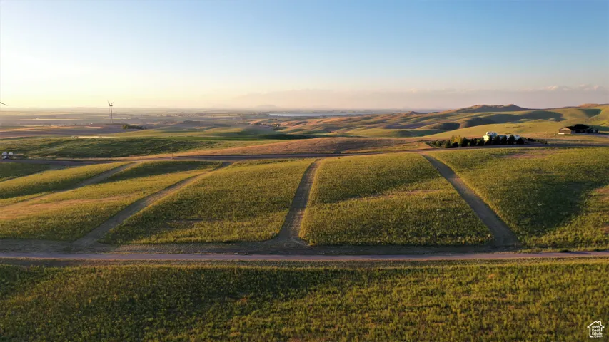 Aerial view at dusk featuring a mountain view and a rural view